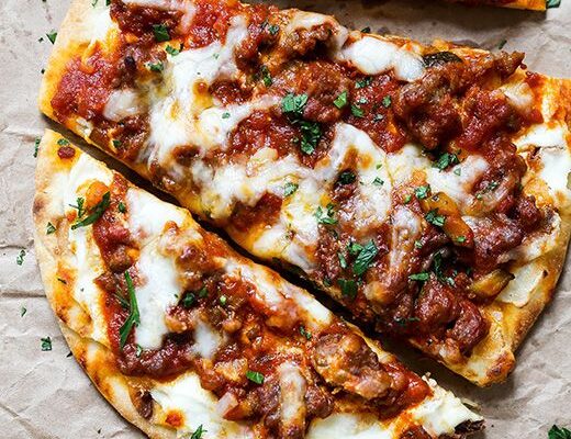 Discover a delicious twist on lasagna with this easy Lasagna Flatbread recipe, featuring layers of meat sauce and creamy cheese in warm flatbread