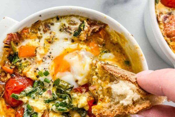 Whip up savory Baked Feta Eggs in just 15 minutes! Tangy feta, fresh veggies, and perfectly baked eggs create a delicious, quick breakfast or brunch dish