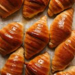 Flaky croissants filled with tangy lemon cheesecake and topped with caramelized sugar for a crème brûlée finish. A decadent twist on classic desserts!