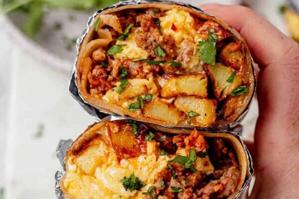 "Learn how to cook a delicious Breakfast Burrito filled with crispy potatoes, zesty chorizo, and scrambled eggs. Perfect for a hearty morning meal!"