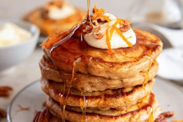 Savor the joy of breakfast with fluffy Carrot Cake Pancakes, drizzled with cream cheese sauce. A delicious twist on a classic dessert!