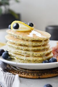 Learn how to cook fluffy Lemon Poppy Seed Pancakes with zesty lemon flavor and poppy seeds, drizzled in homemade syrup for a delightful breakfast treat